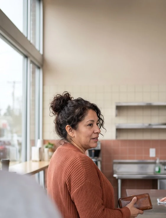 A woman paying at a counter
